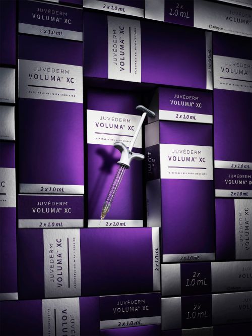 Boxes of Juvederm Voluma XC dermal filler, used in cosmetic procedures, are arranged in a visually appealing stack.