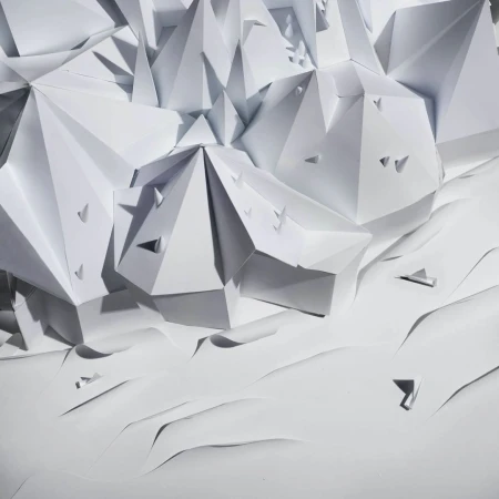 Abstract geometric paper art installation with triangular and pyramidal shapes in a monochromatic white color palette, minimalist design.