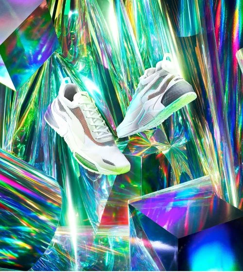 Eye-level shot of two futuristic running shoes levitating against a multifaceted iridescent background, conveying a sense of innovation.