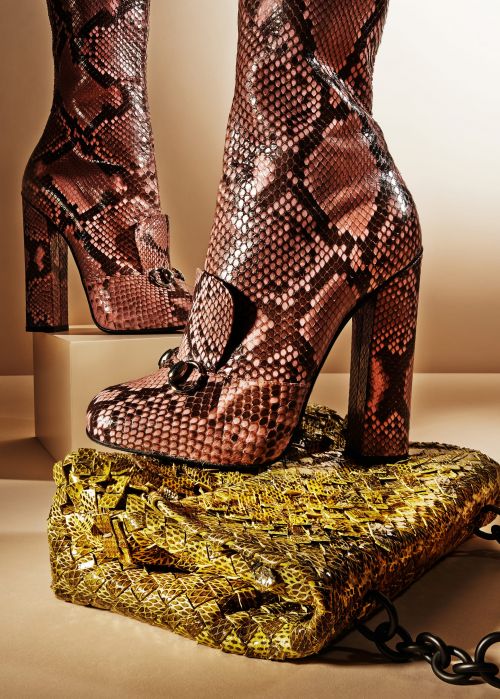 Snakeskin heeled boots and handbag. A stylish pair of snakeskin boots on a platform, paired with a matching patterned handbag.