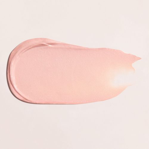 Close-up shot of a pink-colored cosmetic product swatch with a smooth texture on a cream-colored background. Beauty product texture.