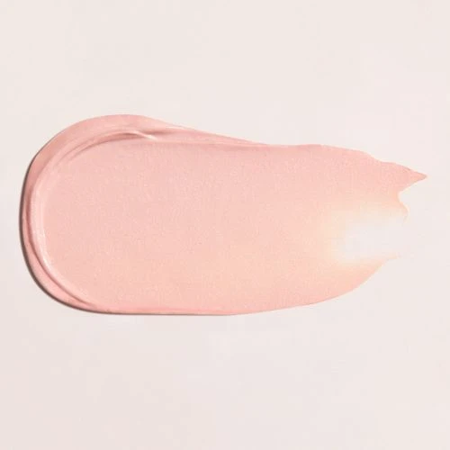 Close-up shot of a pink-colored cosmetic product swatch with a smooth texture on a cream-colored background. Beauty product texture.