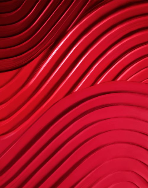 Abstract close-up of red curving architectural forms creating a bold, textured background with layered shapes and dynamic shadows.