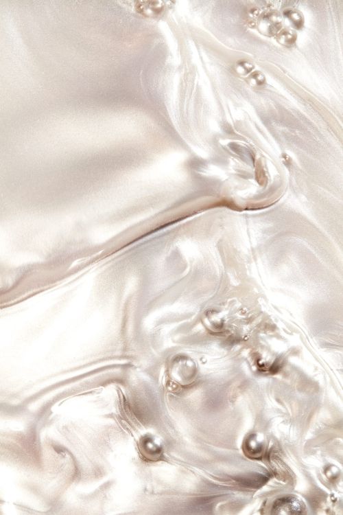 Elegant abstract background with pearls, featuring a flowing pearlescent texture and soft, diffused lighting, creating a luxurious feel.
