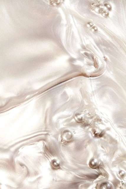 Elegant abstract background with pearls, featuring a flowing pearlescent texture and soft, diffused lighting, creating a luxurious feel.