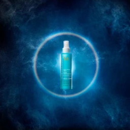 Turquoise spray bottle centered inside a glowing blue circular halo against a dark textured background.