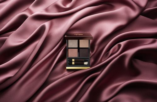 Eye shadow palette on a draped satin fabric. Cosmetic product shot in a beauty and fashion still life.
