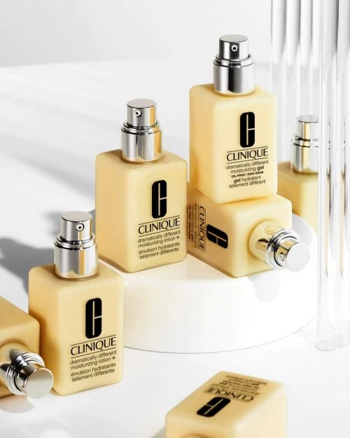 Several bottles of Clinique lotion arranged against a white backdrop in a product shot displaying the brand's skincare line.