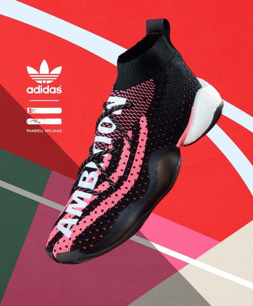 Adidas Pharrell Williams sneaker in black and pink on an abstract red and grey background, showcasing modern athletic shoe design.