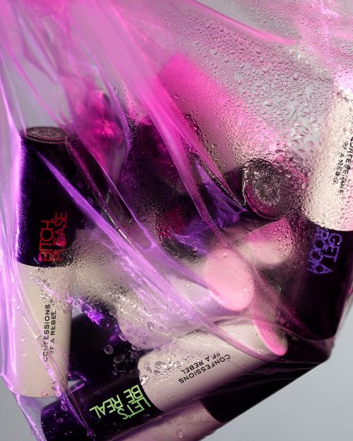 Collection of cosmetic bottles inside a transparent plastic bag with condensation, highlighted by purple and pink lighting.