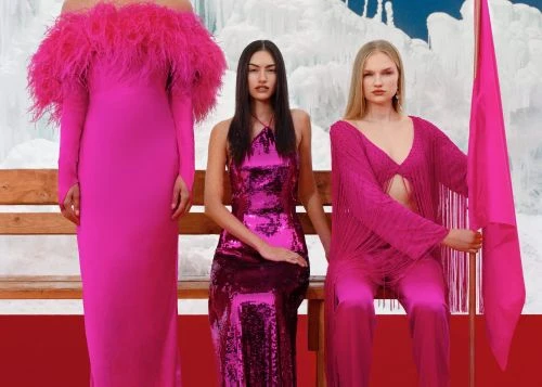 Three women in pink dresses pose on a bench against an icy backdrop. The dresses feature different styles, including feather accents and sequins.