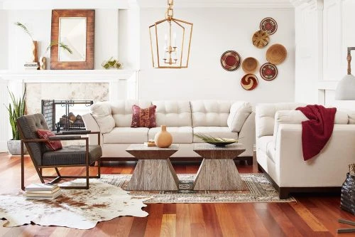 Living room interior with a white couch, wood coffee tables, and decorative wall baskets creates a cozy, stylish, and inviting space.