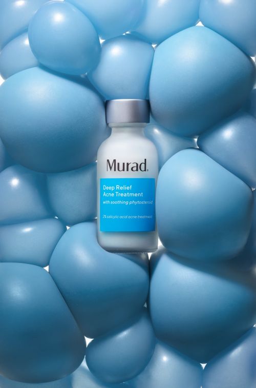 Murad Deep Relief Acne Treatment bottle surrounded by light blue balloons, product shot for beauty or healthcare brand.