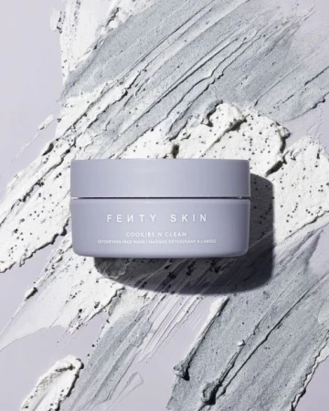 Fenty Skin Cookies N Clean face mask jar against a textured gray and white cosmetic product background. Beauty shot. 