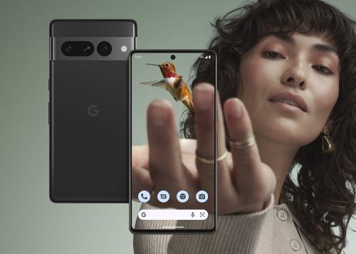 Woman showcasing a Google Pixel phone displaying a hummingbird image, another Pixel phone in the background, neutral studio setting.