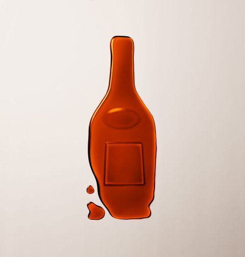 Caramel-colored wax seal resembling a wine bottle on a light background, suggesting a product or brand related to beverages.