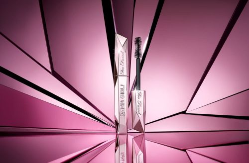 Beauty shot of Too Faced Damn Girl! mascara, tube and brush applicator, against a pink geometric background with reflective surfaces.