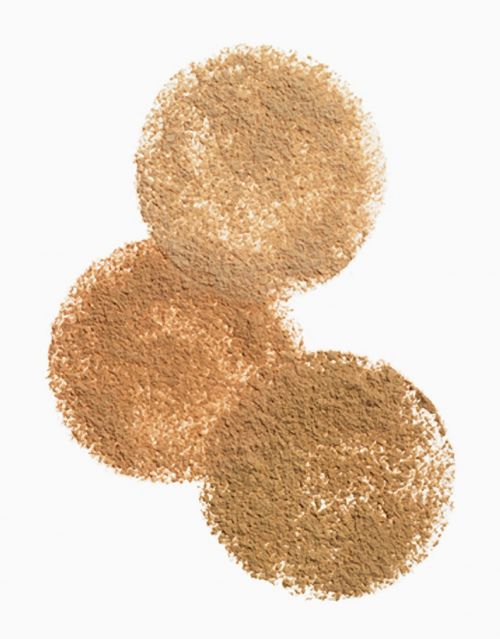 Overlapping circles of bronze-toned cosmetic powder, creating a gradient effect on a white background, for beauty product visuals.