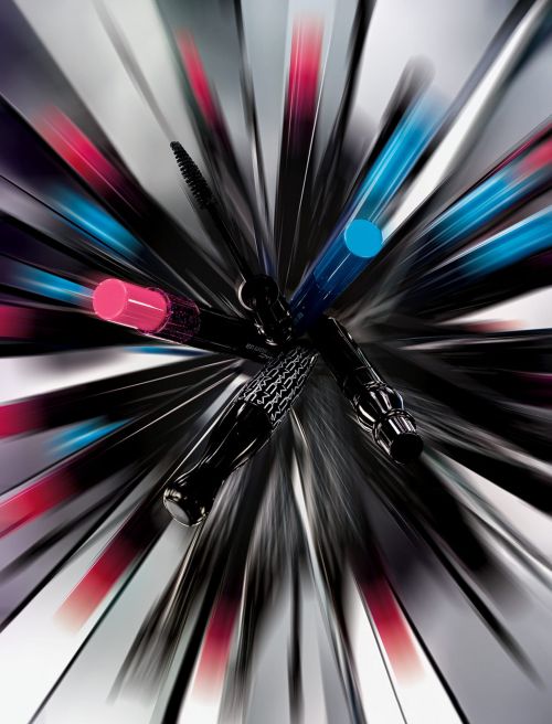 Close-up studio shot of black mascara tubes with pink and blue caps, showcasing beauty product photography and cosmetic advertising.