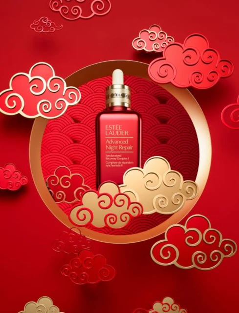 Estee Lauder Advanced Night Repair bottle featured in an advertisement with decorative red and gold clouds on a red background.