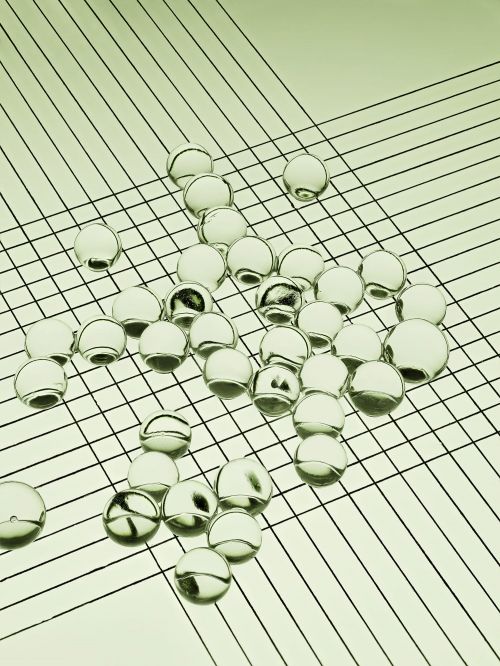 Abstract still life featuring a grid pattern and numerous transparent spheres, creating a modern and minimalist aesthetic composition.
