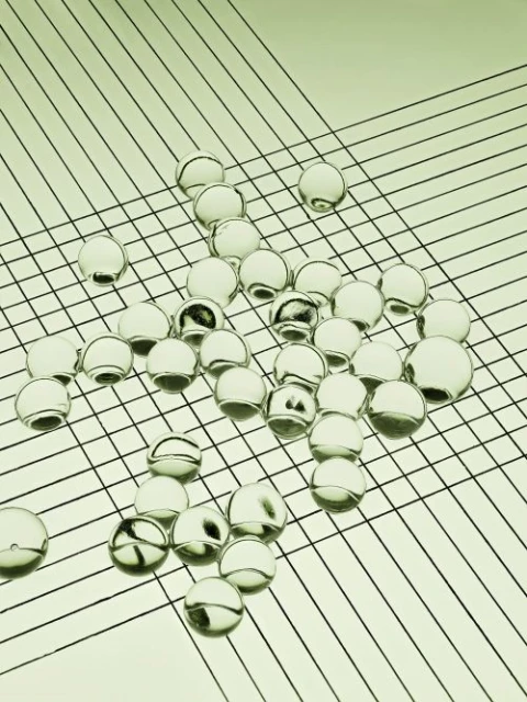 Abstract still life featuring a grid pattern and numerous transparent spheres, creating a modern and minimalist aesthetic composition.