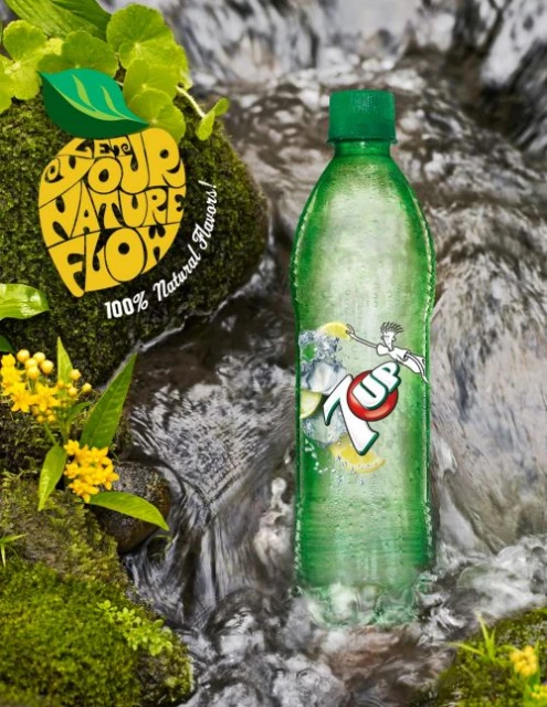 Bottle of 7up lemon-lime soda in a stream with moss, rocks, and a lemon-shaped logo, promoting natural flavors and vibrant refreshment.