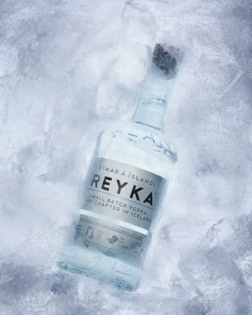 Reyka Icelandic vodka bottle stands out against a frosty backdrop, elegantly showcasing the brand's commitment to purity and craftsmanship.