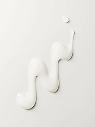A zigzag smear of thick white cream lotion on a pale grey seamless background with a small droplet above.