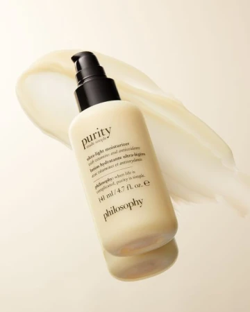 Purity Ultra-Light Moisturizer by Philosophy is displayed with a smear of moisturizer on a light gradient background in a studio shot.