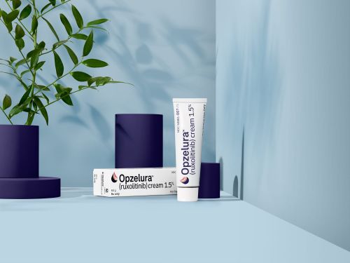 Opzelura cream products and plant on platform in studio with soft blue background and shadows for healthcare or beauty advertising.