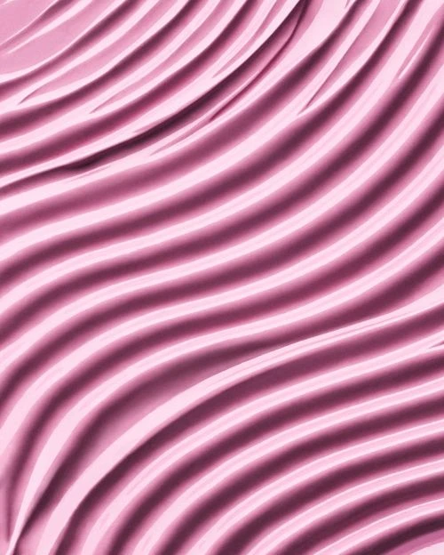 Close-up shot of wavy pink fabric creating a soft, elegant texture and pattern, ideal for backgrounds or abstract visuals.