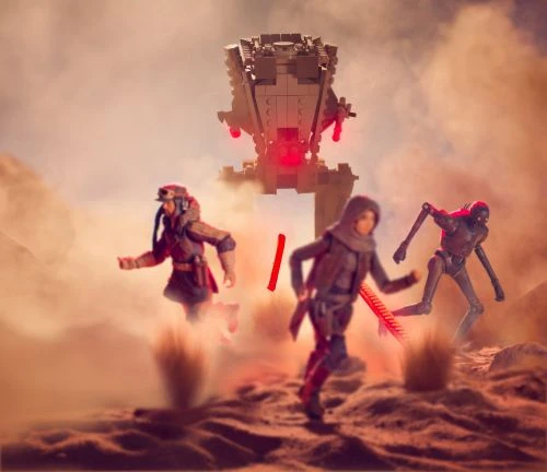 Two figures run across a desert landscape away from a large gray walker, with a robotic figure visible in the background.