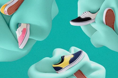 Several Vans brand sneakers are arranged on a swirling pale green surface, showcasing a variety of colors including white, black, yellow, and pink.