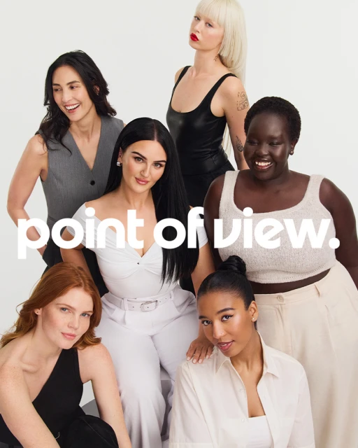 Group of seven diverse women posing in neutral-toned outfits against a white backdrop, embodying modern beauty and fashion.