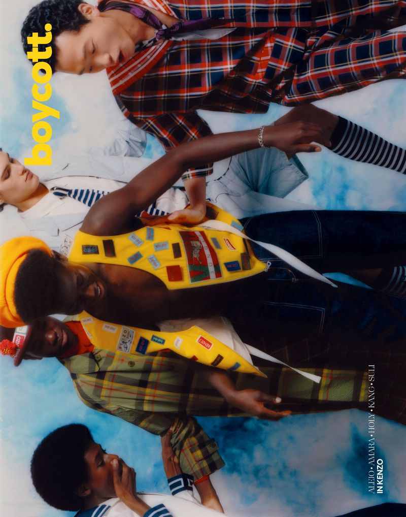 Fashion editorial featuring a group of four people lying down in coordinated outfits, captured with soft lighting and a youthful aesthetic.