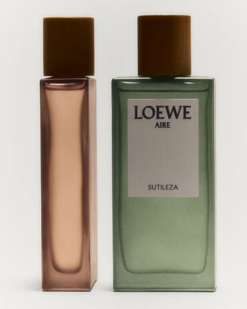 Two Loewe perfume bottles are displayed against a bright white background with a green and brown color palette. The fragrance packaging is minimalist.