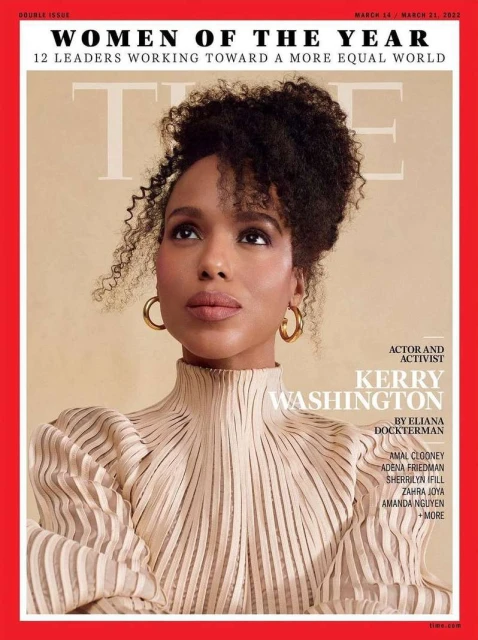 Kerry Washington graces a magazine cover, showcasing her with an updo and gold hoop earrings, wearing a beige high-neck dress, looking upwards.