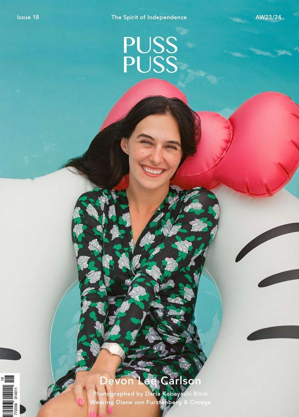 Magazine cover featuring a smiling woman in a floral dress on an inflatable pool toy against a turquoise pool, summery vibe, beauty editorial.