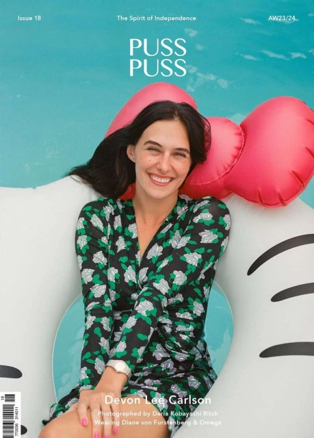 Magazine cover featuring a smiling woman in a floral dress on an inflatable pool toy against a turquoise pool, summery vibe, beauty editorial.