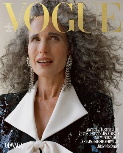 Andie MacDowell on Vogue Polska cover with grey curly hair, wearing a black sequined blazer with a white collar and crystal earrings.