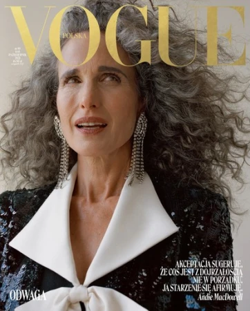 Andie MacDowell on Vogue Polska cover with grey curly hair, wearing a black sequined blazer with a white collar and crystal earrings.