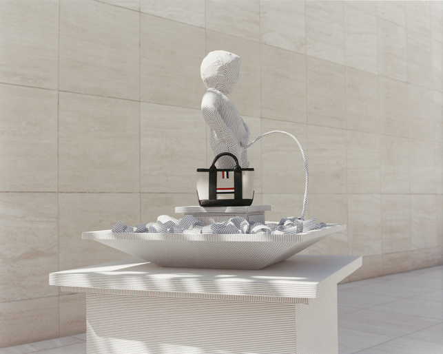 Striking art installation of a statue urinating into a bowl, with a handbag placed next to the statue, all with striped pattern.