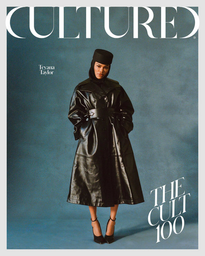 Magazine cover featuring Tevana Taylor in a black leather trench coat and hat, set against a textured blue backdrop, with bold white text.