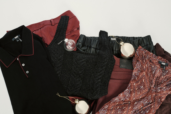 Assorted Paige brand apparel and decorative ornaments arranged on a white surface for a polished product showcase.