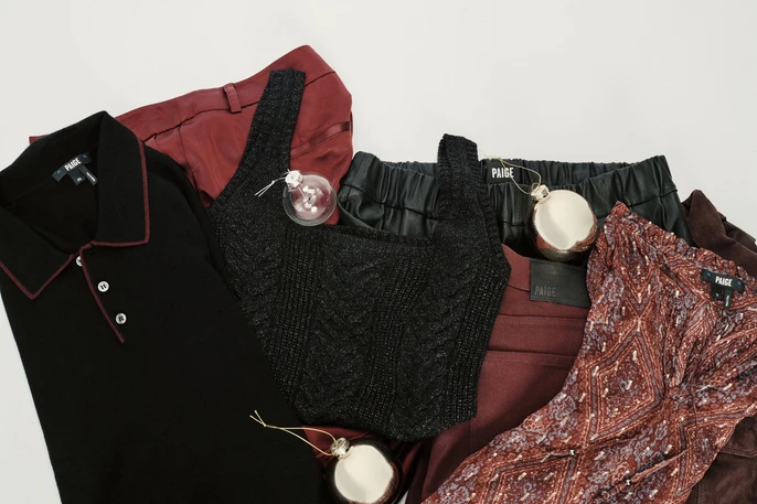 Assorted Paige brand apparel and decorative ornaments arranged on a white surface for a polished product showcase.