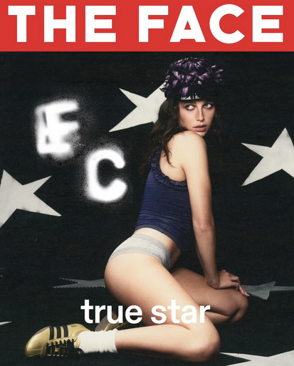 Magazine cover featuring a model in a blue top and briefs kneeling against a black background with white stars and bold typography.