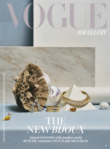 Vogue Jewellery magazine cover featuring an arrangement of jewellery, a shell, and a pearl on a light blue surface, photographed indoors.