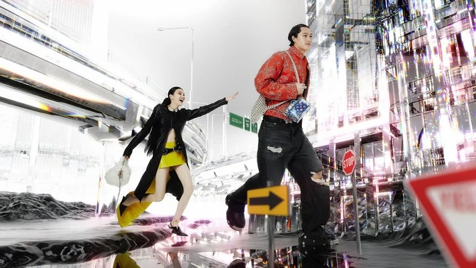Two fashion models stride through a surreal cityscape, one in a black jacket and yellow skirt, the other in red with distressed denim.