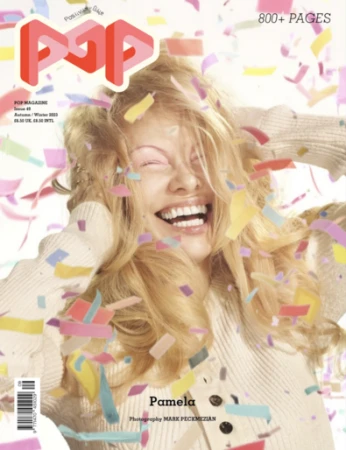 Smiling blonde woman wearing a ribbed cream knit sweater amidst falling colorful confetti with bold typography above
